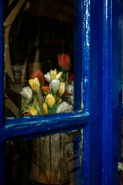 Flowers & Plants - Colorful tulips peek through a vivid blue window #13578498
