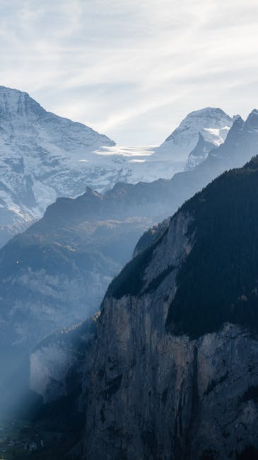 Mountain Landscapes - A breathtaking view of towering snowy peaks and #14699766