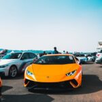 Luxury Cars - An orange Lamborghini stands out at an outdoor c #14843593