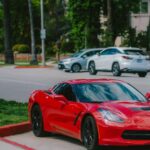Luxury Cars - Red sports car parked on a tree-lined street sho #16735457