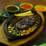 Food Aesthetics - Sizzling steak served with fries and three flavo #29899522