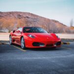 Luxury Cars - A stunning red Ferrari car parked against a scen #30599907