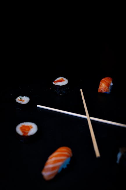 Food Aesthetics - Assorted sushi pieces and chopsticks on a black #31286807