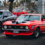 Luxury Cars - Classic red Mustang parked outdoors, embodying A #33419719