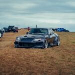 Luxury Cars - A modern sports car parked on a grassy field wit #36421083