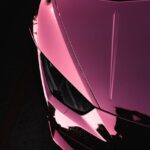Luxury Cars - Close-up of a shiny pink luxury sports car highl #6891804