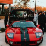 Luxury Cars - A striking red Ford GT with black stripes displa #6891810